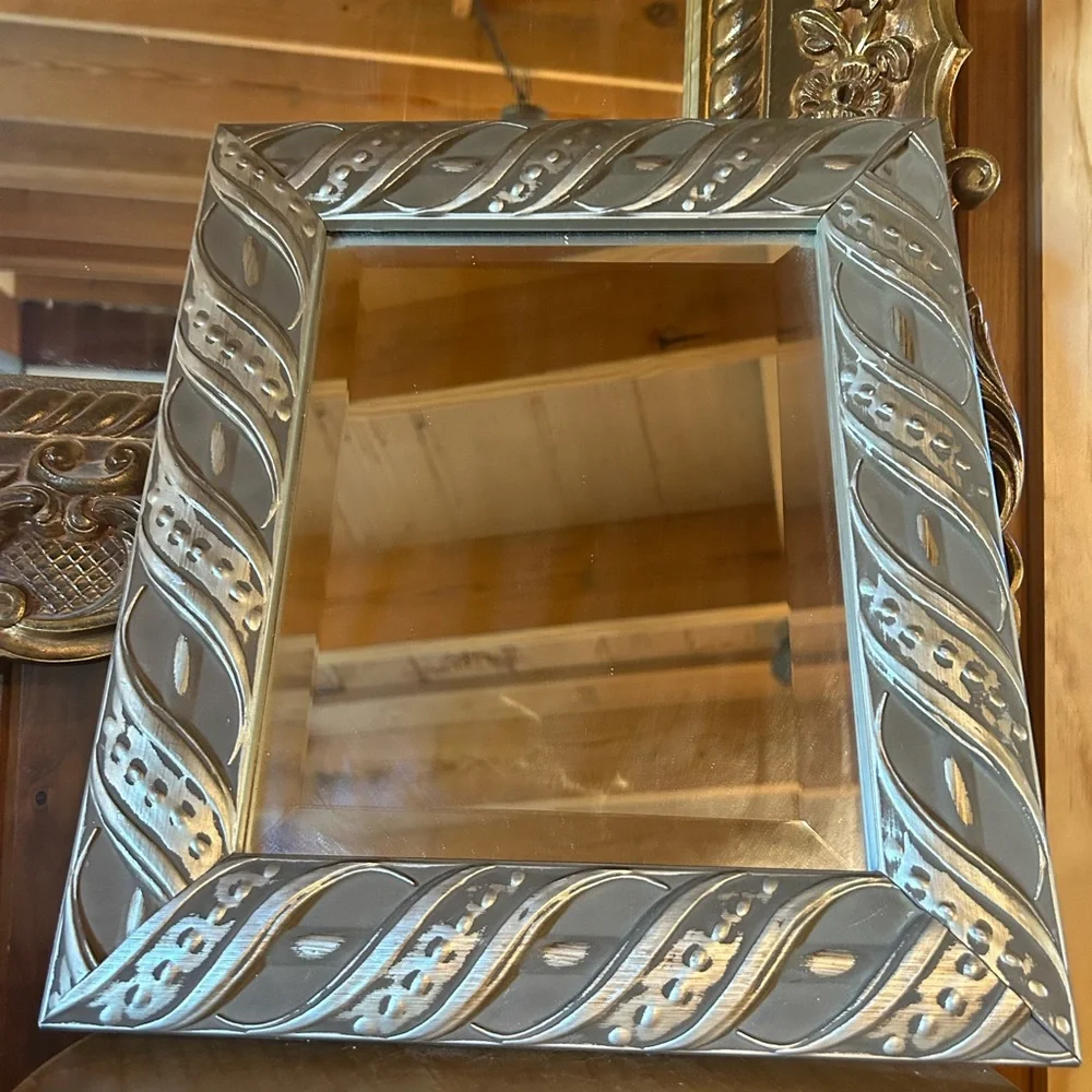 Silver framed mirror with beveled mirror. Good vintage condition.
